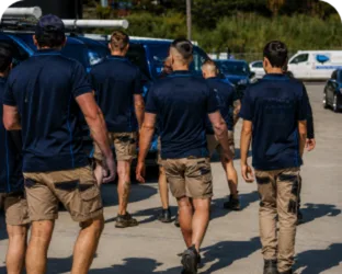 Plumbers walking to their service vans on a Bella Vista job